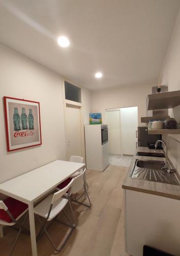 a kitchen with a table and a table and a counter at Appartamento a due passi dal mare. Civitanova M. in Civitanova Marche