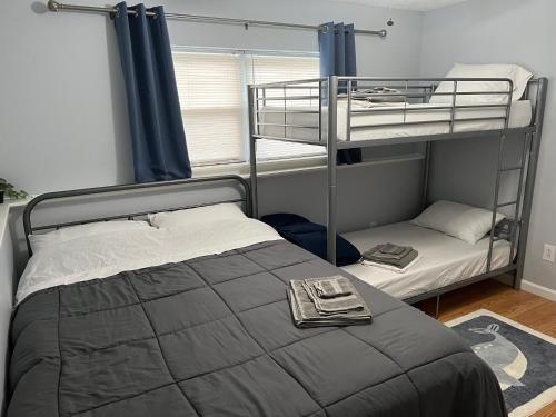 a bedroom with two bunk beds and a window at Spacious Pocono Home with Hot Tub and Fire Pit in Long Pond