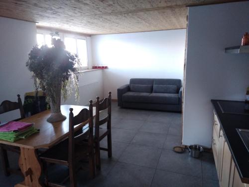 a living room with a table and a couch at Appartement panex sur ollon / proche Villars in Ollon