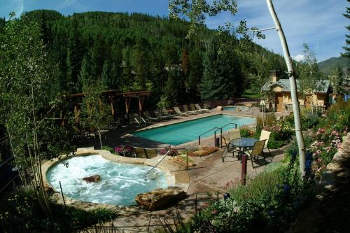 a swimming pool in a yard with a mountain at Antlers at Vail Resort in Vail