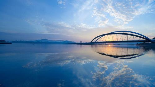 a bridge over a large body of water at Cyberjaya Eclipse 5 Plus 2 PAX Blissful Suite in Cyberjaya