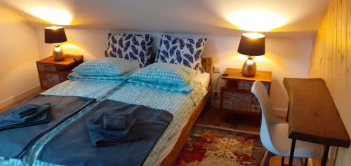 a bedroom with a bed and a desk with two lamps at Domek nad Solinką in Żubracze