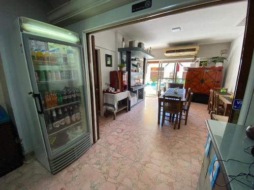 a room with a refrigerator and a dining room at Palermo Soho Hostel in Buenos Aires