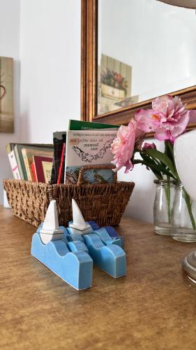 a basket of books on a table next to a table at GolfoParadiso Uscio bombon - PellicceriaSuperior in Uscio