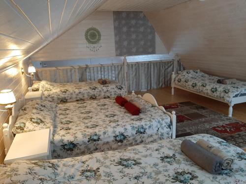 a bedroom with three beds in a attic at Otsa puhkemaja in Raudsepa