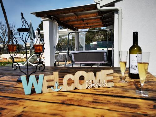 a wooden table with wine glasses and a bottle of wine at Villa Molo in Novigrad Istria