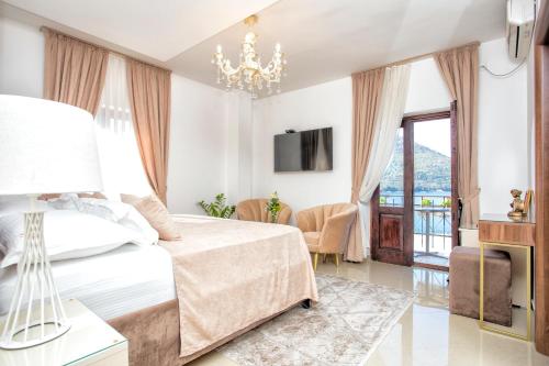 um quarto com uma cama e um lustre em Hotel Admiral em Perast