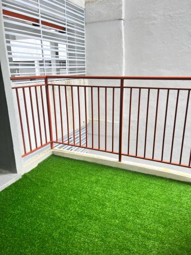 a balcony with green grass in a room at Emerald Avenue Cozy 1BR Studio Suite in Brinchang