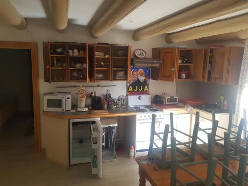 a kitchen with wooden cabinets and a counter top at Appartneuville in Vielsalm