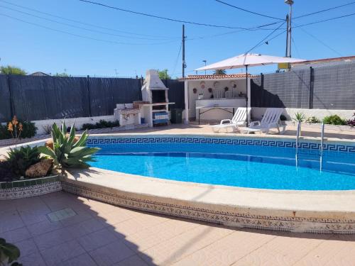 a swimming pool in the backyard of a house at Casa El Cornijal - Piscina Privada in San Javier