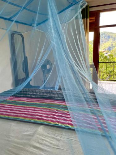 a bed with a net on top of it at Top Heaven in Ella