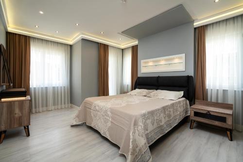 a bedroom with a large bed and a television at Holiday in Antalya