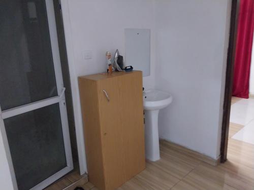 a bathroom with a sink and a white toilet at 2 spacious bedrooms in Mombasa