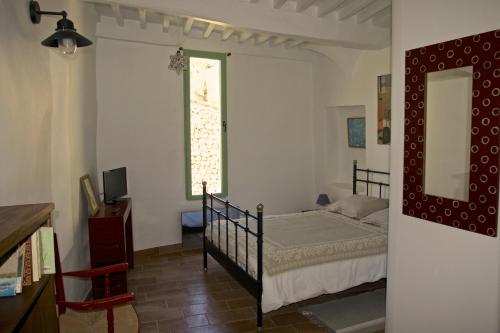 a bedroom with a bed and a large window at La Bonne Etoile - The Good Star in Moustiers-Sainte-Marie