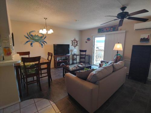 a living room with a couch and a table at Bay Tree B4 in Port Aransas