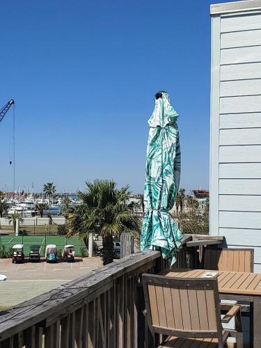 a statue on a deck with a table and benches at Bay Tree B4 in Port Aransas