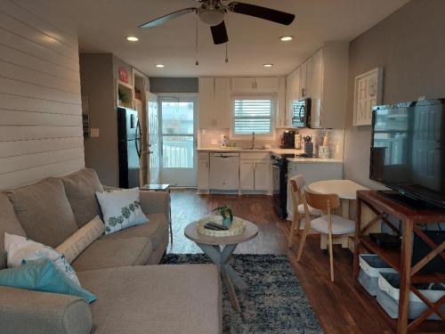 a living room with a couch and a table and a kitchen at Bay Tree B3 in Port Aransas