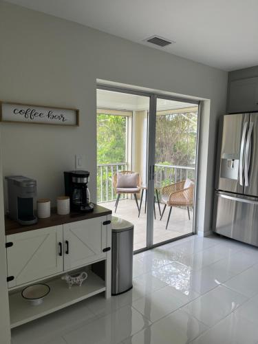 a kitchen with a refrigerator freezer next to a patio at Great location with lake view in Naples