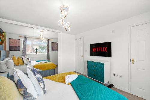 a bedroom with two beds and a mirror at Designer House in Bristol - Hot Tub - Sleeps 10 in Bristol