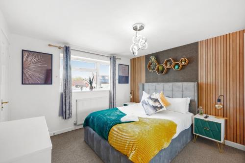 a bedroom with a large bed and a window at Designer House in Bristol - Hot Tub - Sleeps 10 in Bristol