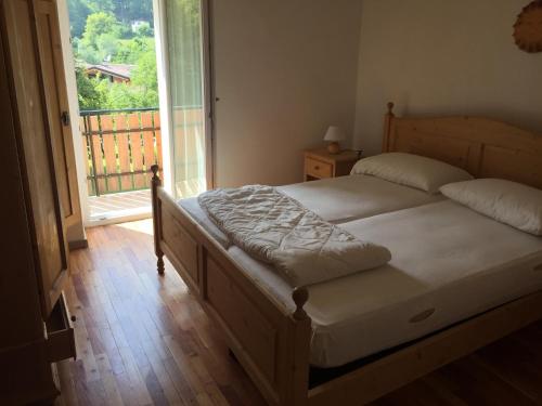 a bedroom with two beds and a large window at Via Roma41 in Chiesa