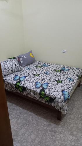 a bed with blue butterflies on it in a room at Ikea flat 5 in Hurghada