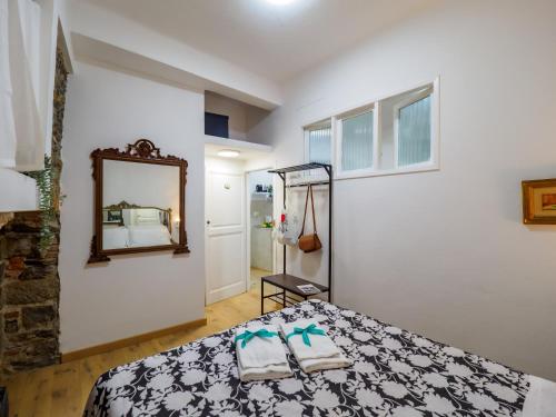 a bedroom with a bed and a mirror at Specciu Cozy Apartment in Vernazza