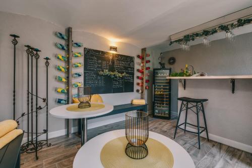 a coffee shop with two tables and a chalkboard at Villa17 in Badacsonytomaj