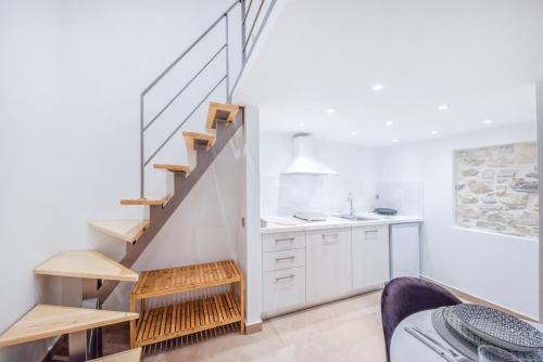 a kitchen with a staircase and a sink at Aristotelous Gerry Studio in Corfu Town