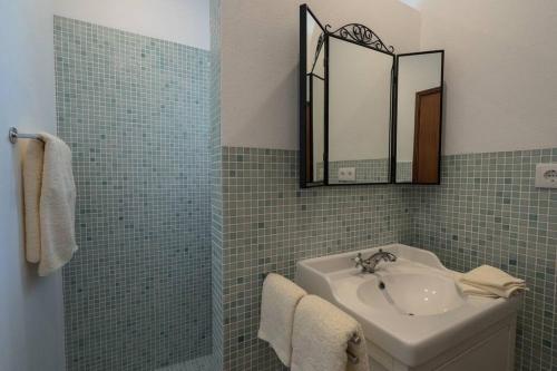 a bathroom with a sink and a mirror at Casa a pequena sereia in Benagil with sea view in Carvoeiro