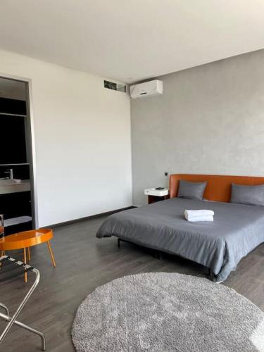 a bedroom with a bed and a table and a rug at Luxury Palm Villa in Marrakech