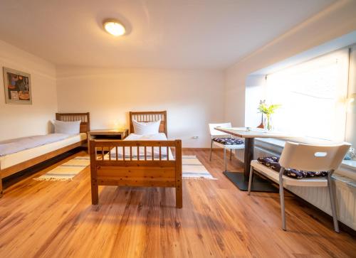 a bedroom with a bed and a desk and a table at Ferienwohnung Kruppa in Plön