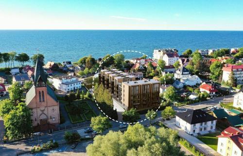 an aerial view of a small town by the ocean at Słoneczny Apartament in Ustronie Morskie