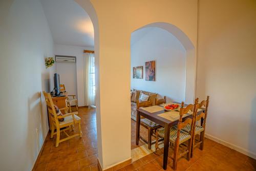a dining room and kitchen with a table and chairs at Apartment Zeus with private pool and sea view in Nisakion