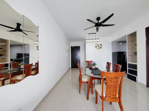 a dining room and kitchen with a table and chairs at Symphony Tower 3BR High Floor 100mbps Wi-Fi Netflix in Cheras