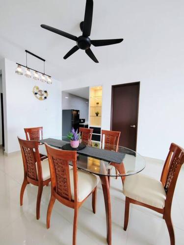 a dining room table with chairs and a ceiling fan at Symphony Tower 3BR High Floor 100mbps Wi-Fi Netflix in Cheras