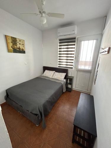 a bedroom with a bed and a table in it at Maroulitsas Sea Esta 1 in Haraki