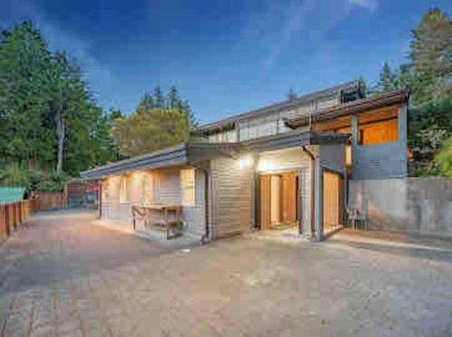 a house with a large driveway in front of it at The Lions Self Contained Suite, Shared Pool, Hot Tub, Views in North Vancouver