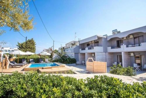 an apartment building with a swimming pool in front of it at Yianna Apartments in Faliraki