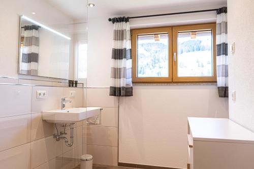 a bathroom with a sink and a mirror at Thaler Höhe in Oberstaufen