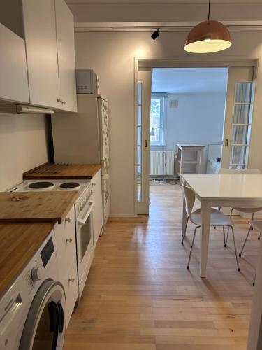 a kitchen with a table and a dining room at Holiday house near forrest, harbor and beach in Vedbæk