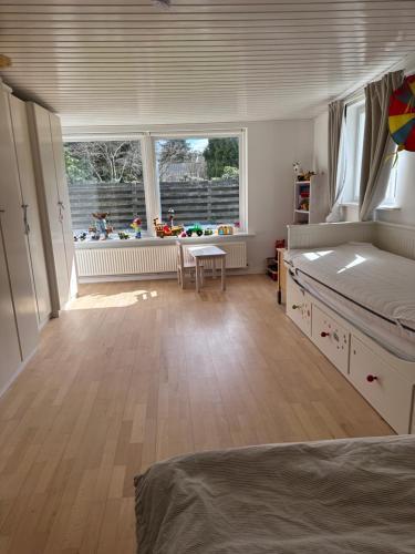 a bedroom with a bed and a table and a window at Holiday house near forrest, harbor and beach in Vedbæk