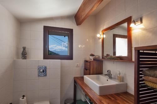 y baño con lavabo y espejo. en Casa Poggio, en Barbaggio