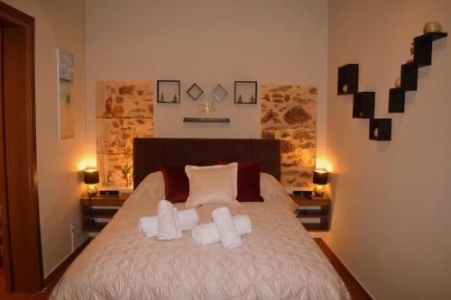 a bedroom with a bed with two pillows at Harmony 2 in Gold in Lávrion