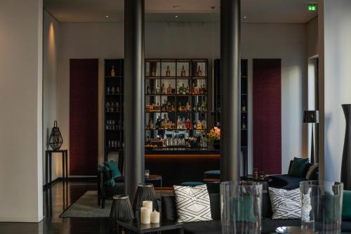 a lobby with a bar in the background at A-ROSA Hotel Ceres am Meer - Adults Only in Binz