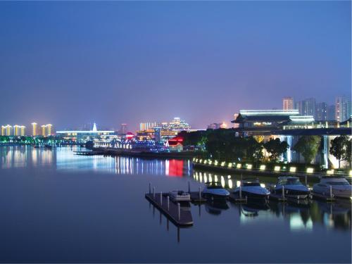 a group of boats docked in a harbor at night at Tonino Lamborghini Hotel Suzhou in Suzhou
