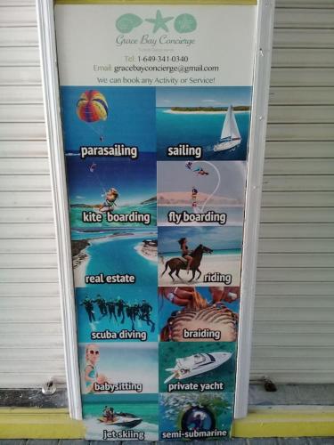 a sign on the side of a building with different signs at Private Guest House 2 bedrooms & 2 baths near Grace Bay Beach & Long Bay Beach. in Providenciales