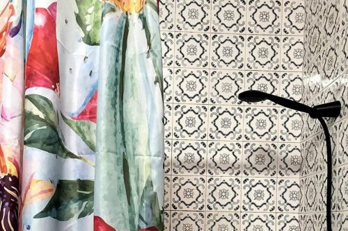 a lamp sitting next to a wall with a curtain at 10 to Ocean in Figueira da Foz