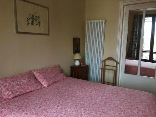 1 dormitorio con cama rosa y ventana en casa silvio pellico en Cuneo