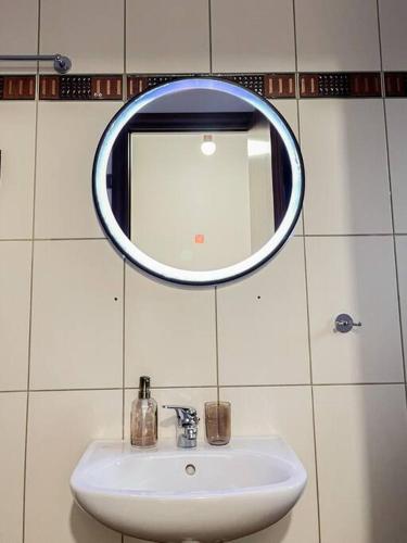 a bathroom with a sink and a mirror on the wall at Afroditi's Apartment Superb View in Gythio